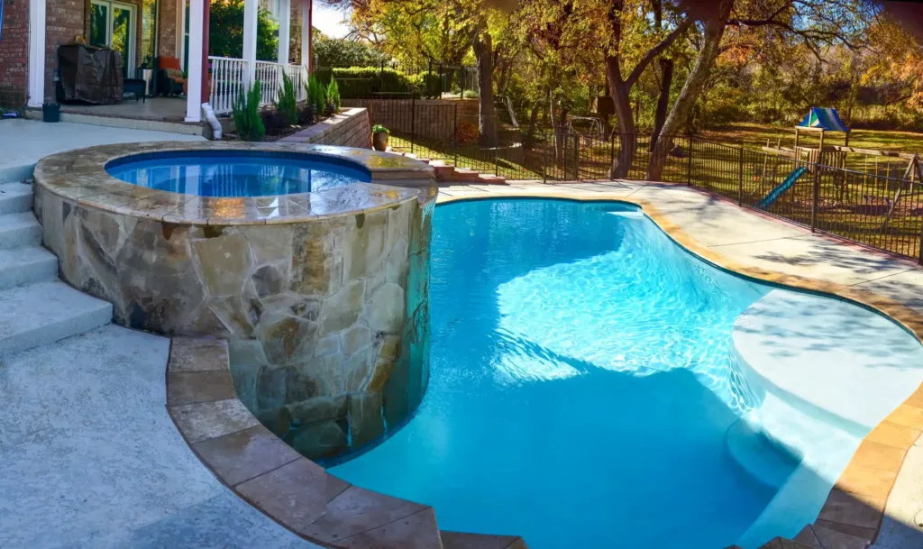 Private pool with jacuzzi and landscaped backyard